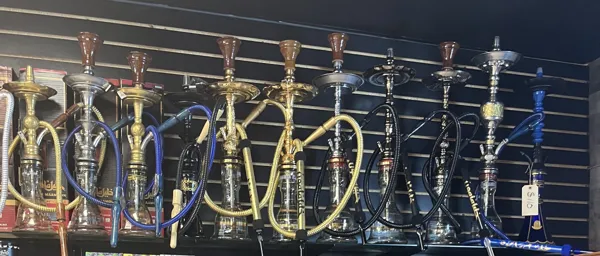 A rack of hookahs in brass, steel and colored glass with blue and gold hoses